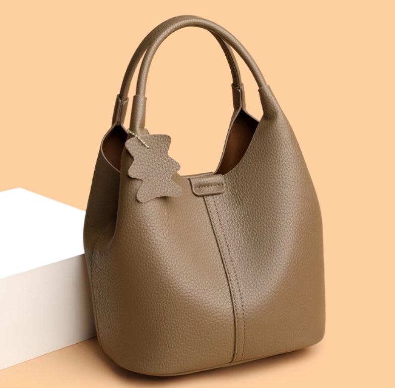 Leather women's bag - 2025 new style, fashionable and versatile, single shoulder crossbody bag with high-end and niche design, handbag in the shape of a water bucket.